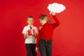 Valentine`s day celebration, happy caucasian kids isolated on red background Royalty Free Stock Photo