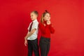 Valentine`s day celebration, happy caucasian kids isolated on red background Royalty Free Stock Photo