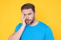 Thougthful thinking man looks pensively aside makes plannings isolated over yellow background. Handsome thinking man