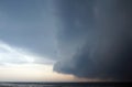 Thoundstorm with Dark clouds coming over the calm lake with an alone bird flying in the sky to the storm Royalty Free Stock Photo