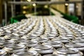 Thousands of beverage aluminum cans on conveyor line at factory