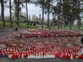 Thousands of candles light on graveyard, with cross and trees