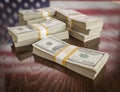 Thousands of Dollars with Reflection of American Flag on Table Royalty Free Stock Photo
