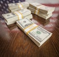 Thousands of Dollars with Reflection of American Flag on Table Royalty Free Stock Photo