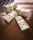 Thousands of Dollars with Reflection of American Flag on Table Royalty Free Stock Photo