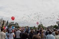 Thousands of white balloons released into sky at parade on vic