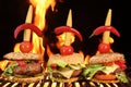 Thre Homemade Cheeseburger Close-up On Flaming Barbecue Grill Ba Royalty Free Stock Photo