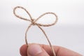 Thread knot in hand Royalty Free Stock Photo