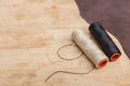 Thread for leather on wooden background