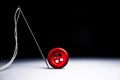 Thread needle and red button isolated Royalty Free Stock Photo