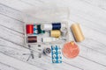 thread needles sewing supplies in a plastic box on a wooden background