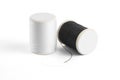Thread spool on a white background. Basic color of thread: White, Black. Royalty Free Stock Photo