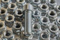 The threaded bolt lies on the shiny hex nuts. Royalty Free Stock Photo