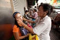 Threading (hair removal) in Chinatown Bangkok. Royalty Free Stock Photo