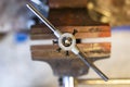 threading on a part clamped in an old iron vise in the workshop Royalty Free Stock Photo