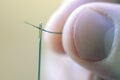 Threading a sewing needle