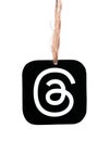 Threads mobile app icon hanging on sackcloth thread on white background close-up. Meta Officially Launches Threads which