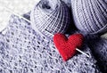 Threads with red handmade knitted heart Royalty Free Stock Photo