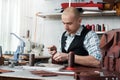 Sewing leather goods, close-up of the process. master in the process of hand sewing the product Royalty Free Stock Photo