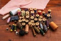 Threads and sewing supplies lie on a wooden table. Royalty Free Stock Photo