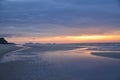 A threatening stormy but picturesque tropical orange and grey coloured cloudy coastal sunrise seascape Royalty Free Stock Photo