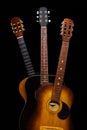 Three acoustic guitars on black background