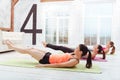 Three active women exercising hard in gym