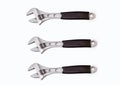 Three adjustable wrenches on a white background are located one above the other