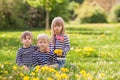 Three adorable kids, dressed in striped shirts, hugging and smiling Royalty Free Stock Photo