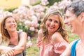 Three adult women sitting in the park laughing and chatting