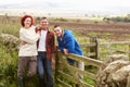 Three adults in countryside