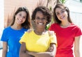 Three african american and caucasian girlfriends in colorful shirts Royalty Free Stock Photo