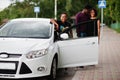 Three african american friends stay near car.