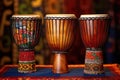 three african djembe drums in a row