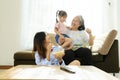 Three age ranges, Asian niece and grandma enjoying watching movies Royalty Free Stock Photo