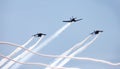 Three airplanes in formation with smoke