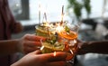 Three alcoholic cocktail with fruit pieces, mint and sparklers close up. Royalty Free Stock Photo