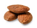 Three almond nuts. White isolated background. Macro.