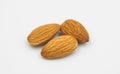 Three almond seeds on white background