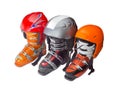 Three alpine ski boots and ski helmets
