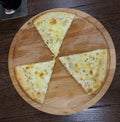 Three alternating pieces of pizza on wooden substrate looking similar to sign of radioactivity Royalty Free Stock Photo