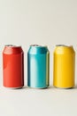 Three aluminum cans with drinks on a light background. Royalty Free Stock Photo