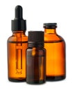 Three Amber Glass Bottles With Dropper Tops on White Background Royalty Free Stock Photo