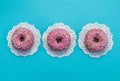 Three american donuts with pink icing. Royalty Free Stock Photo