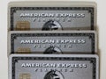 Three American Express Amex Platinum Cards on a White Table
