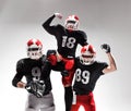 The three american football players posing on white background