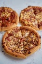 Three american style pizzas served on a table