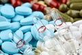 Three ampoules with medicine and many colorful pills Royalty Free Stock Photo