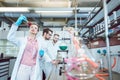 Three analytical chemists doing research in the lab