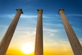 Three ancient columns on a dramatic sunset